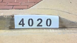 Painted curb address number 4020 in black on a white background, Los Angeles