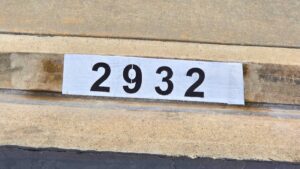 Painted curb address number 2932 in black on a white background, Los Angeles